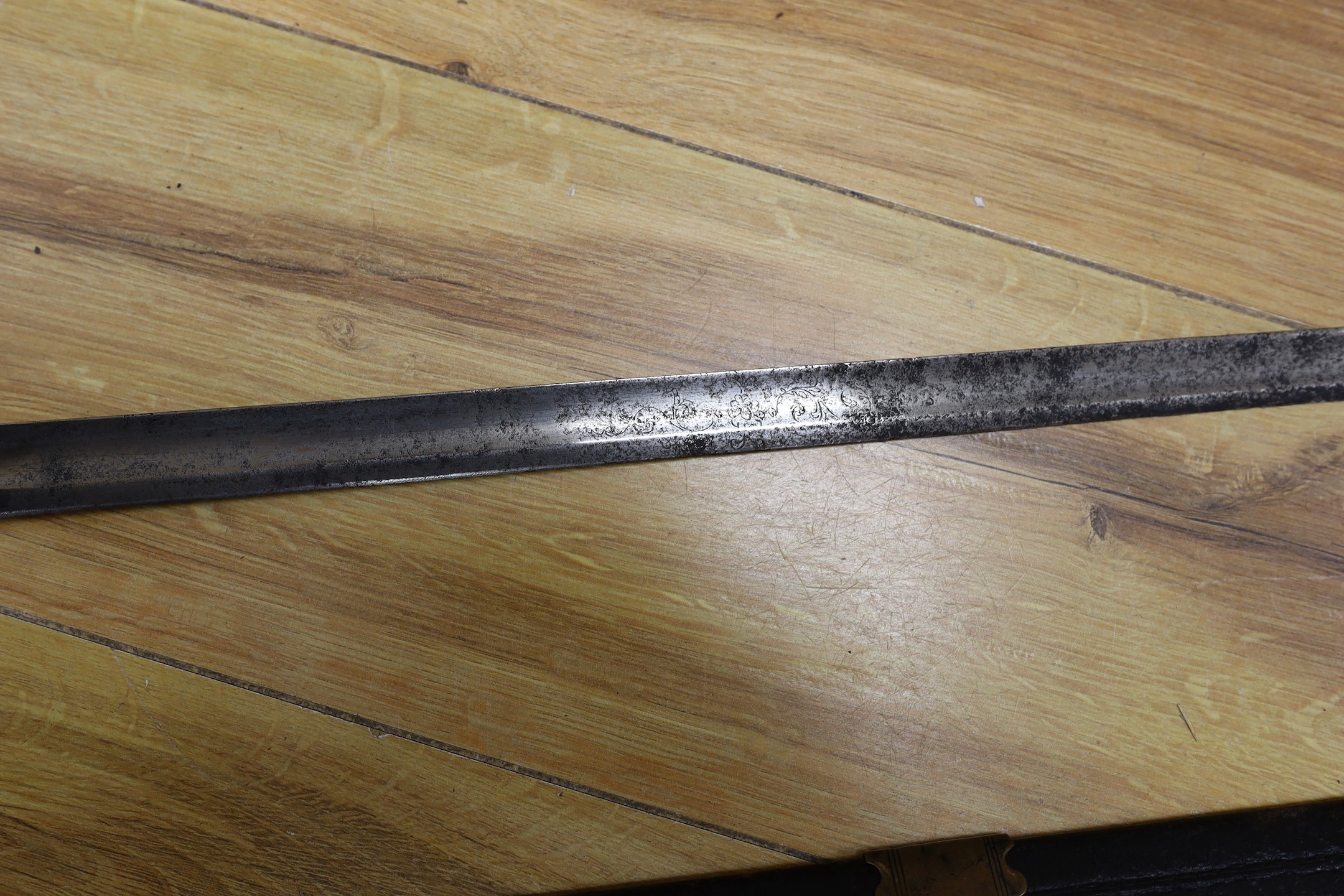 An 18th century European brass hilted sword and scabbard. 89cm long